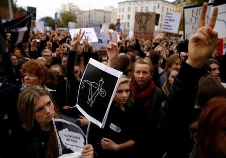 Women gesture as people gather in an abortion rights campaigners' demonstration to protest against plans for a total ban on abortion in front of the ruling party Law and Justice (PiS) headquarters in Warsaw, Poland October 3, 2016. REUTERS/Kacper Pempel/File photo
