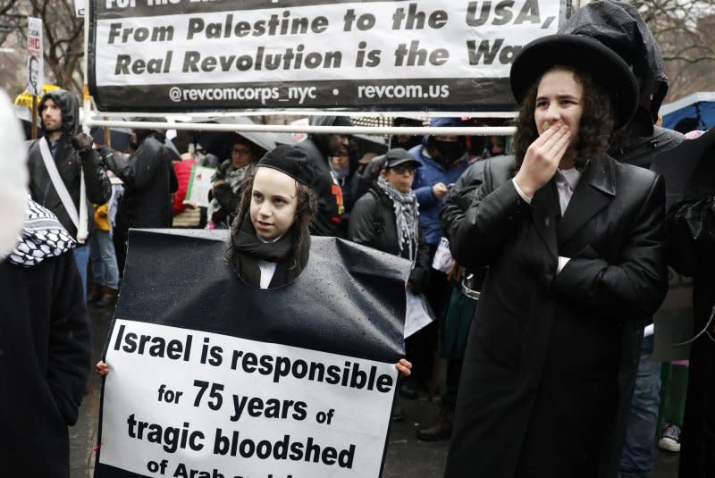 Protesters hold signs and umbrellas as rain falls at the Hands Off Rafah Ceasefire Now Stop The Genocide protest in response to the Israeli-Palestinian conflict in Washington Square Park on Saturday, March 2, 2024 in New York City. Photo by John Angelillo/UPI