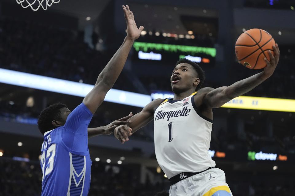 Marquette's Kam Jones shoots over Creighton's Fredrick King during the first half of an NCAA college basketball game Saturday, Dec. 30, 2023, in Milwaukee. (AP Photo/Morry Gash)