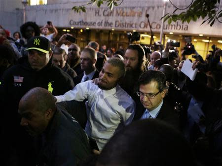 Rapper Chris Brown (C) departs the District of Colombia courthouse in Washington October 28, 2013. Brown was arrested and charged with felony assault in Washington early on Sunday after getting into a fight with a man outside the W hotel near the White House, Officer Anthony Clay of the Metropolitan Police Department said. REUTERS/Gary Cameron