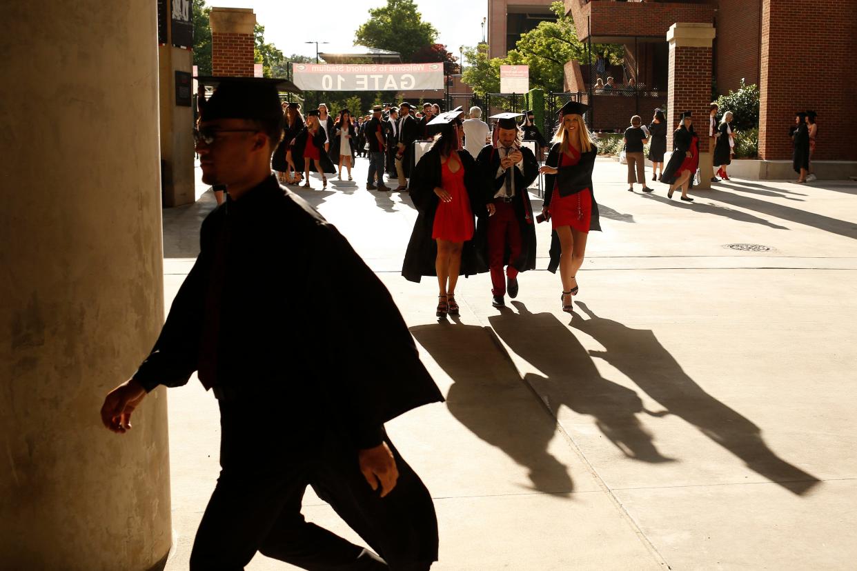 Graduates arrive for the University of Georgia's spring undergraduate commencement ceremony on Friday, May 13, 2022.