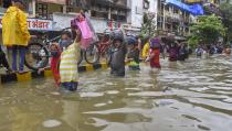 Mumbai: People wade through a waterlogged street at Parel area, after heavy monsoon rain, in Mumbai, Wednesday, Sept. 23, 2020. (PTI Photo)(PTI23-09-2020_000077A)