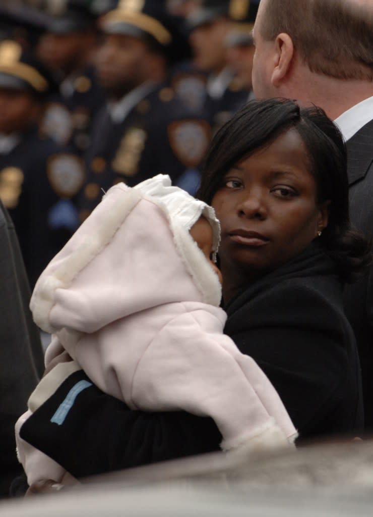 Leslyn Stewart, the wife of the fallen P.O. Dillon Stewart pictured with their daughter Samantha at her husband’s wake at the New Life Tabernacle in East Flatbush on East 49th Street in Brooklyn. Paul Martinka