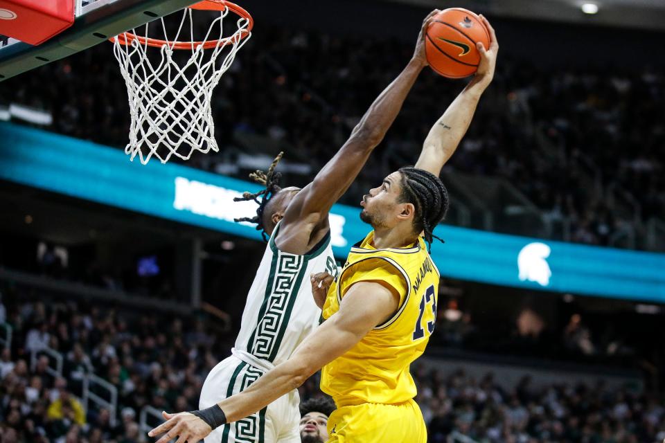 Michigan State forward Coen Carr (55) blocks a dunk against Michigan forward Olivier Nkamhoua (13) during the first half at Breslin Center in East Lansing on Tuesday, Jan. 30, 2024.