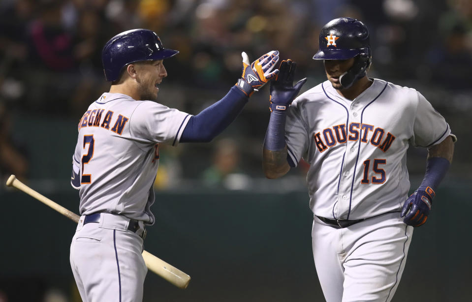 Houston Astros' Martin Maldonado, right, celebrates with Alex Bregman after hitting a home run off Oakland Athletics' Edwin Jackson during the fifth inning of a baseball game Friday, Aug. 17, 2018, in Oakland, Calif. (AP Photo/Ben Margot)