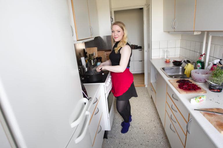 Anne Sofie Udklit Soerensen from Aarhus in Denmark, a member of the DinnerSurfer-community, prepares a meal in her kitchen on April 4, 2014