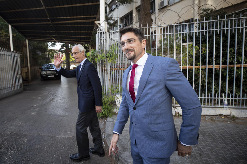 Members of Carlos Ghosn's defense team, lawyer Jean Yves Le Borgne, left, and Jean Tamalet leave the Justice Palace in Beirut, Lebanon, Monday, May 31, 2021. A team of French investigators began questioning ex-Nissan boss Carlos Ghosn in Beirut on Monday over suspicions of financial misconduct, Lebanese judicial officials said. (AP Photo/Hassan Ammar)