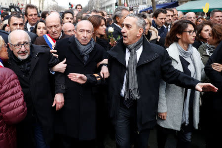 People and officials including French Interior Minister Gerard Collomb (C) and CRIF Jewish organisation president Francis Kalifat attend a gathering, organised by the CRIF, in memory of Mireille Knoll, in Paris, France, March 28, 2018. REUTERS/Gonzalo Fuentes