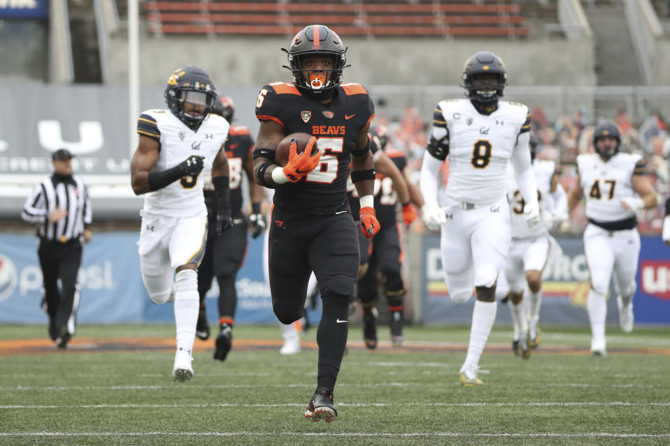 FILE - In this Nov. 21, 2020, file photo, Oregon State running back Jermar Jefferson (6) runs 75-yards to score a touchdown on the first play of an NCAA college football game against California in Corvallis, Ore. Jefferson was selected as the PAC-12 offensive player of the year along with Colorado running back Jarek Broussard. (AP Photo/Amanda Loman, File)