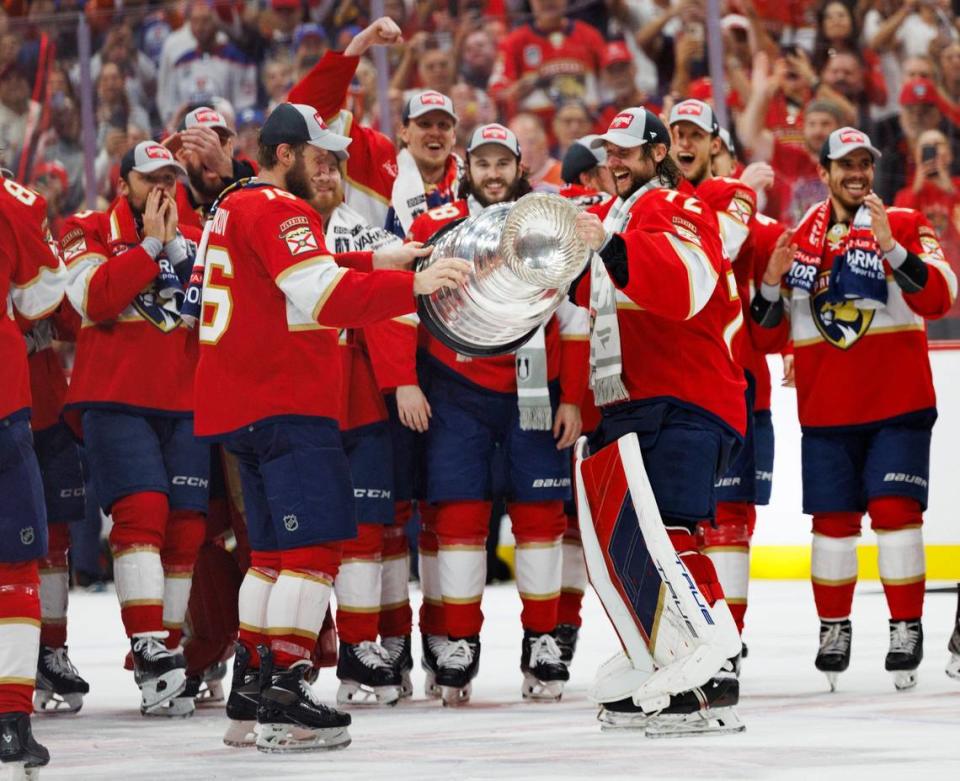 Florida Panthers captain Aleksander Barkov (16) passes the cup to goaltender Sergei Bobrovsky (72) after the Florida Panthers won Game 7 of the NHL Stanley Cup Final at the Amerant Bank Arena on Monday, June 24, 2024 in Sunrise, Fla.
