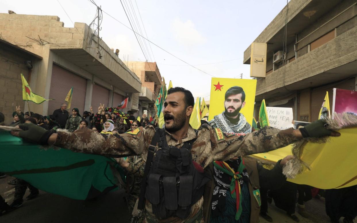 A member of the Kurdish People's Protection Units (YPG) takes part in a demonstration against a threatened Turkish assault - AFP