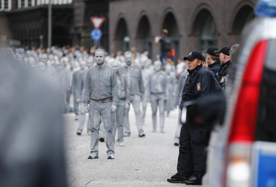 <p>Participants in the so called “1000 Figures” demonstration perform near German police before the upcoming G20 summit in Hamburg, Germany, July 5, 2017. (Hannibal Hanschke/Reuters) </p>