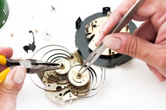 Watchmaker working on a complicated clockwork system.