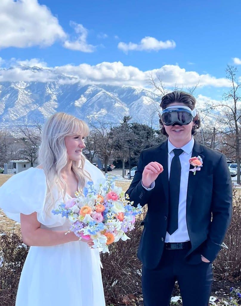 Jacob Wright extends his hand out to seemingly use a control panel on his Apple Vision Pro headset, while his wife looks in disgust. @jason, /X