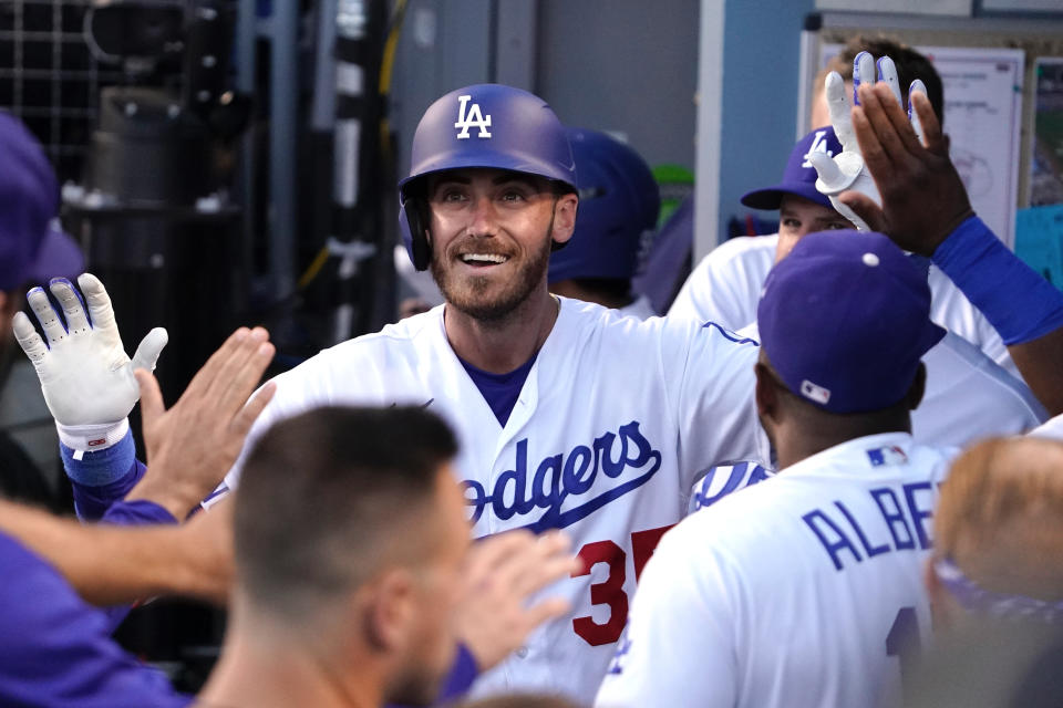 Los Angeles Dodgers' Cody Bellinger is congratulated by teammates in the dugout after hitting a solo home run during the second inning of a baseball game against the Cleveland Guardians Friday, June 17, 2022, in Los Angeles. (AP Photo/Mark J. Terrill)