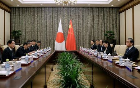 China's Foreign Minister Wang Yi (R) talks with Japanese Foreign Minister Fumio Kishida (L) during a meeting at Diaoyutai State Guesthouse, in Beijing, China, April 30, 2016. REUTERS/Jason Lee