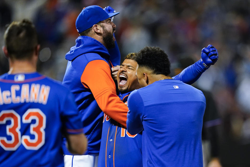 New York Mets' Eduardo Escobar celebrates with teammates after hitting a walk-off RBI single during the first inning of a baseball game against the Miami Marlins Wednesday, Sept. 28, 2022, in New York. The Mets won 5-4. (AP Photo/Frank Franklin II)