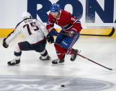 Montreal Canadiens defenseman Mike Matheson (8) and Columbus Blue Jackets defenseman Tim Berni (75) vie for the puck during the first period of an NHL hockey game Saturday, March 25, 2023, in Montreal. (Peter McCabe/The Canadian Press via AP)