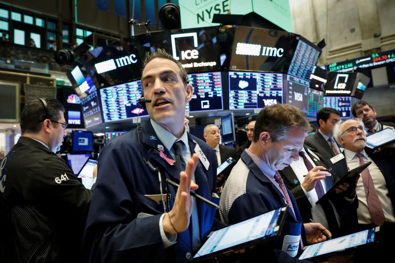 Traders work on the floor at the NYSE in New York