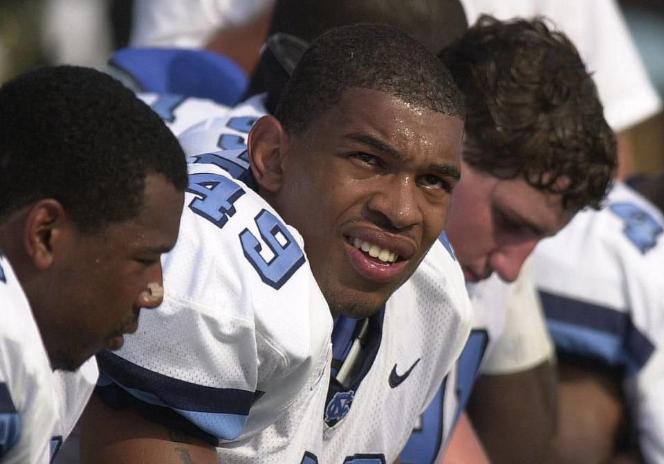 UNC defensive end Julius Peppers (center) on the bench during a game in 2000.
