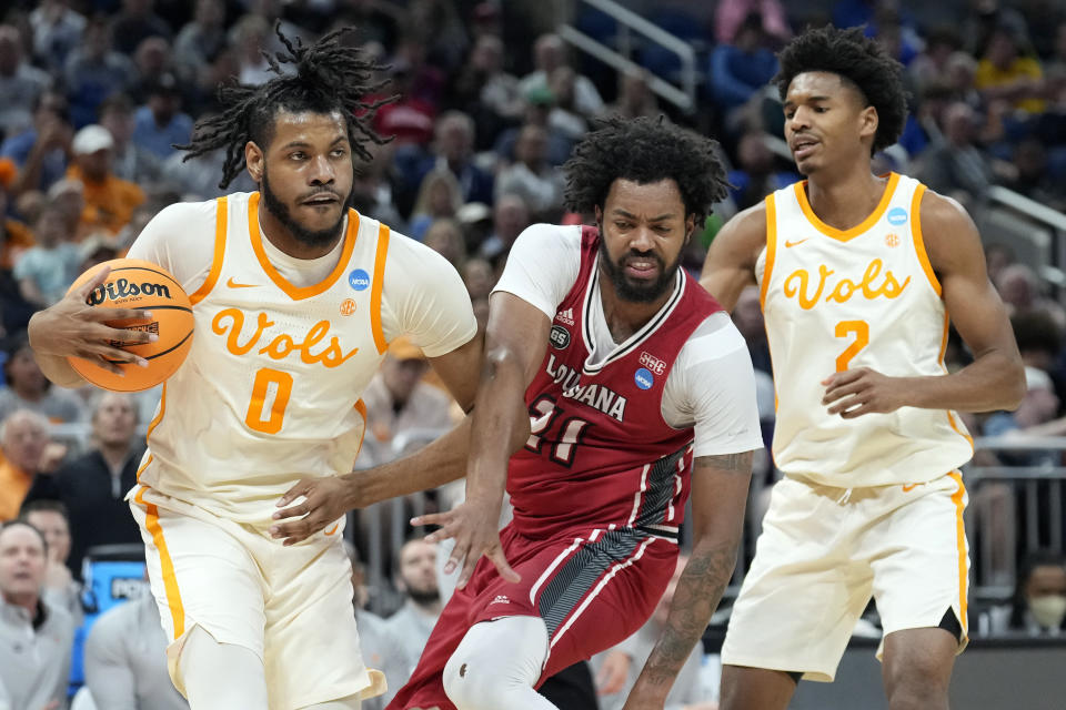 Tennessee forward Jonas Aidoo (0) steals a rebound from Louisiana forward Jordan Brown (21) during the first half of a first-round college basketball game in the NCAA Tournament, Thursday, March 16, 2023, in Orlando, Fla. Tennessee's Julian Phillips, right, looks on. (AP Photo/Chris O'Meara)