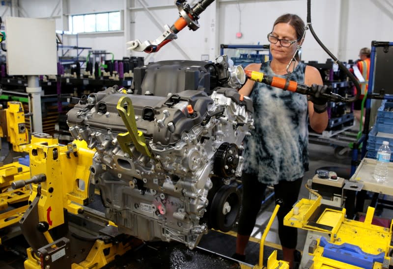 A General Motors assembly worker works on assembling a V6 engine, used in a variety of GM cars, trucks and crossovers, at the GM Romulus Powertrain plant in Romulus,