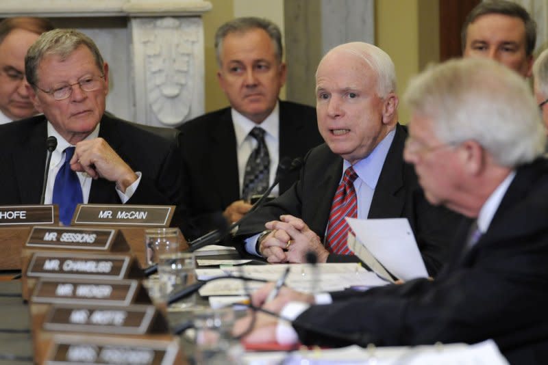 Senate Armed Services Committee member Sen. John McCain, R-Ariz. (2nd from R), comments as Sen. James Inhofe, R-Okla. (far L) listens as they meet to vote on sending the nomination of former Sen. Chuck Hagel as the next secretary of Defense to the floor of the Senate on Feb. 12, 2013. File Photo by Mike Theiler/UPI