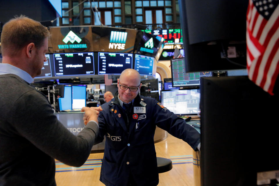 Traders fist bump following the market close on the floor at the New York Stock Exchange (NYSE) in Manhattan, New York City, U.S., February 9, 2018. REUTERS/Andrew Kelly