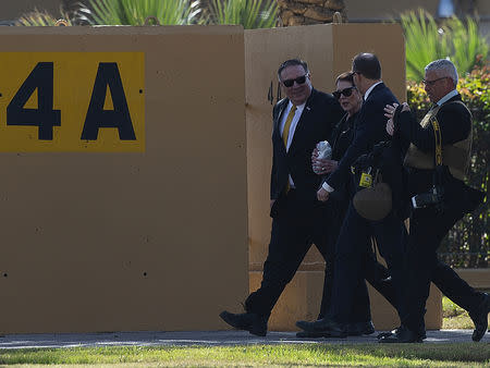 FILE PHOTO: U.S. Secretary of State Mike Pompeo and his wife Susan walk at the U.S. Embassy compound toward the heli pad to catch a helicopter that will transport them to the International Airport, in Baghdad, Iraq, January 9, 2019. Andrew Caballero-Reynolds/Pool via REUTERS/File Photo