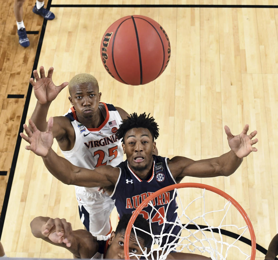 Auburn's Anfernee McLemore (24) and Virginia's Mamadi Diakite (25) reach for a rebound during the second half in the semifinals of the Final Four NCAA college basketball tournament between Auburn and Virginia, Saturday, April 6, 2019, in Minneapolis. (Jamie Schwaberow/NCAA Photos via Getty Images via AP, Pool)