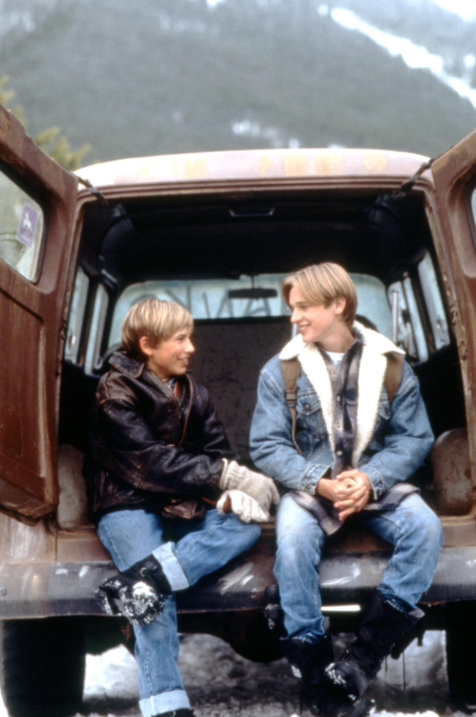 Jonathan and Devon smiling and sitting in the back of a van