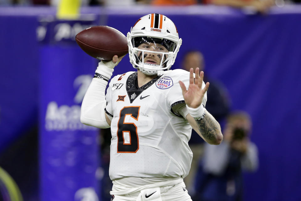 Oklahoma State quarterback Dru Brown looks to pass the ball against Texas A&M during the first half of the Texas Bowl NCAA college football game Friday, Dec. 27, 2019, in Houston. (AP Photo/Michael Wyke)