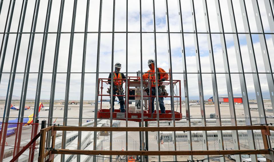 Jose Navarrete and Luis Resendiz, both with Daw Construction Group, work on phase three of the Salt Lake City International Airport construction outside of Concourse B in Salt Lake City on Tuesday, June 20, 2023. | Kristin Murphy, Deseret News