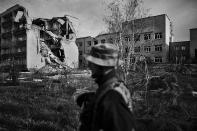 <p>A Ukrainian soldier walks near a hospital damaged by artillery of Russian-backed rebels in Marynka, Ukraine, April 2017. (Photo: Manu Brabo/MeMo) </p>