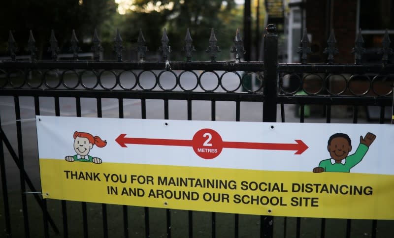 A social distancing sign is seen on the gate of a school as the spread of the coronavirus disease (COVID-19) continues in Hale