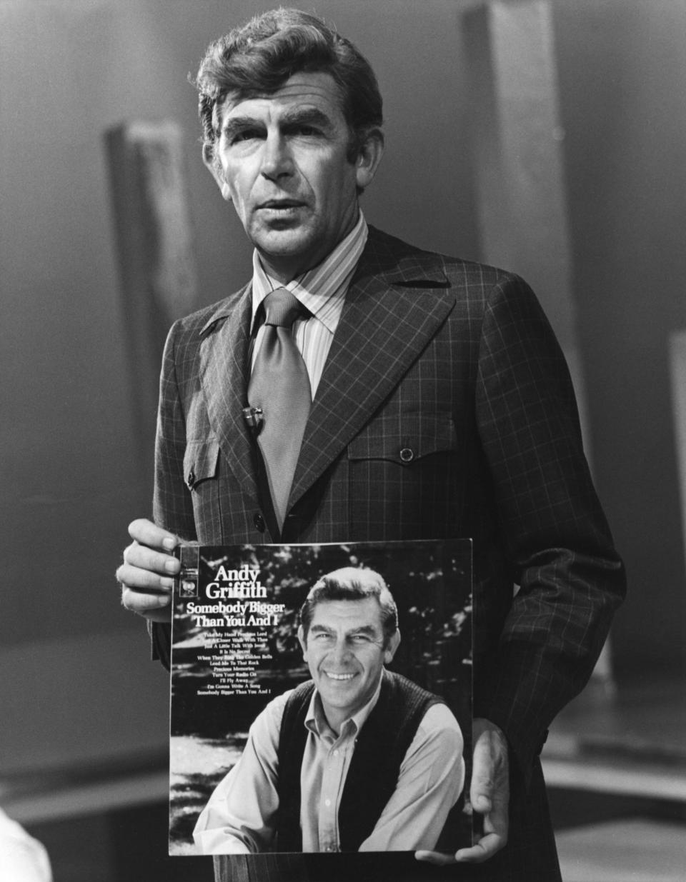 <span><span>Actor and singer Andy Griffith holds his album 'Somebody Bigger Than You And I' in 1972</span><br><span>Michael Ochs Archives/Getty</span></span>