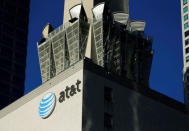 An AT&T logo and communication equipment is shown on a building in downtown Los Angeles, California October 29, 2014. REUTERS/Mike Blake/File Photo