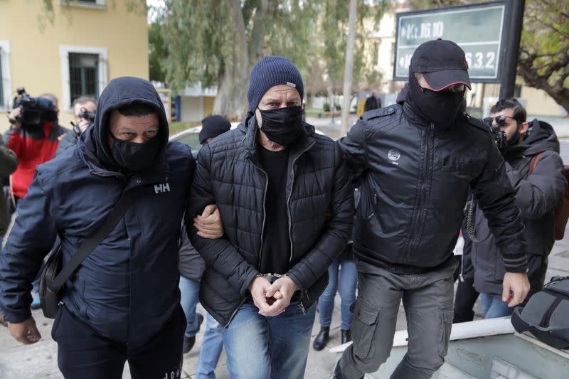 Greek actor and former director of Greece's National Theatre Lignadis is escorted by police officers to the prosecutor's office, in Athens