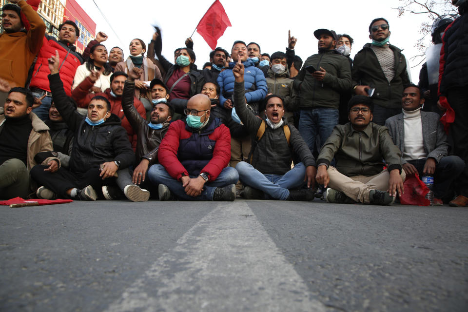 Nepalese students affiliated with Nepal Student Union chant slogans against prime minister Khadga Prasad Oli during a protest in Kathmandu, Nepal, Sunday, Dec. 20, 2020. Nepal’s president dissolved Parliament on Sunday after the prime minister recommended the move amid an escalating feud within his Communist Party that is likely to push the Himalayan nation into a political crisis. Parliamentary elections will be held on April 30 and May 10, according to a statement from President Bidya Devi Bhandari's office. (AP Photo/Niranjan Shrestha)