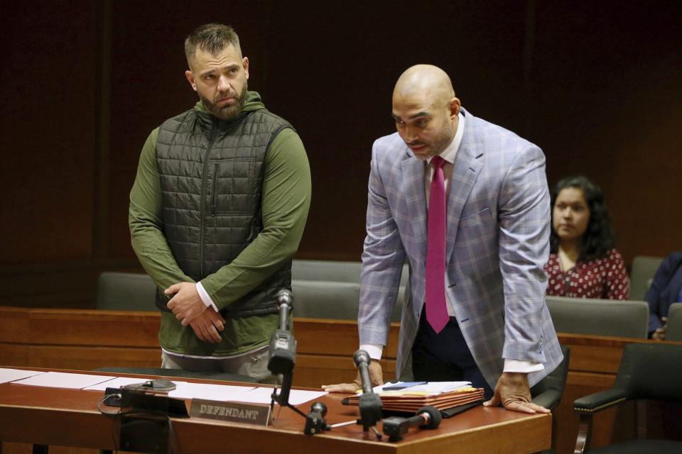 Mark D'Amico, left, stands with his lawyer, Mark Davis, as he pleads guilty to one count of misappropriating entrusted funds in Burlington County Superior Court in Mount Holly, N.J., on Friday, Dec. 6, 2019. Along with his then-girlfriend, Kate McClure, and a homeless man, Johnny Bobbitt, D'Amico allegedly set up a false online fundraiser and kept the money for themselves. (Tim Tai/The Philadelphia Inquirer via AP)