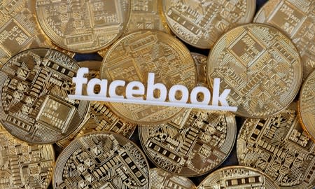 Facebook logo is seen on representations of virtual currency in this illustration picture