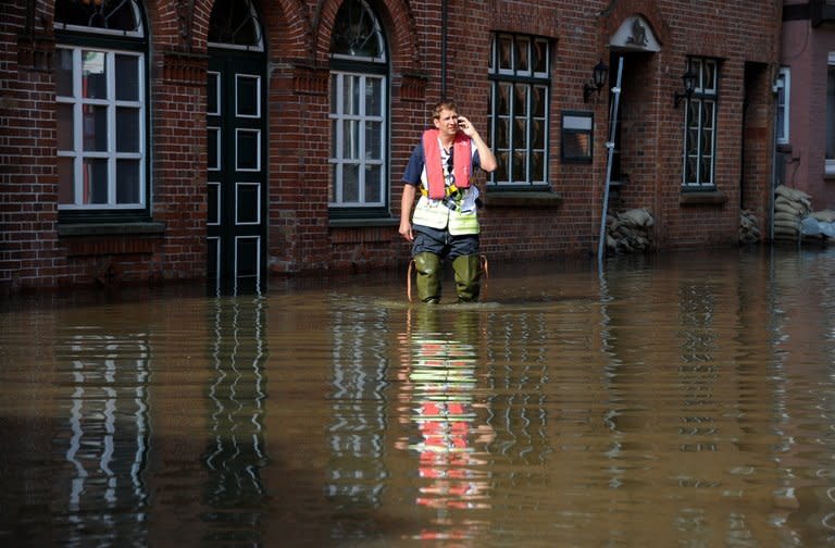A fireman works in the old town of Lauenburg, northern Germany, flooded by the river Elbe on June 11, 2013. Deadly floods forging a path of devastation through central Europe for more than a week bore down on northern Germany Tuesday as new estimates emerged on the cost of the damage