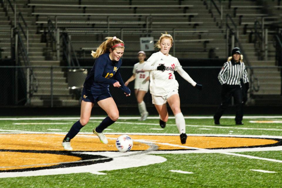 Moon Tigers junior forward Sydney Felton goes for the ball against Mars senior Gwen Howell in Moon's 2-0 victory over Mars in the PIAA semifinals at North Allegheny High School.