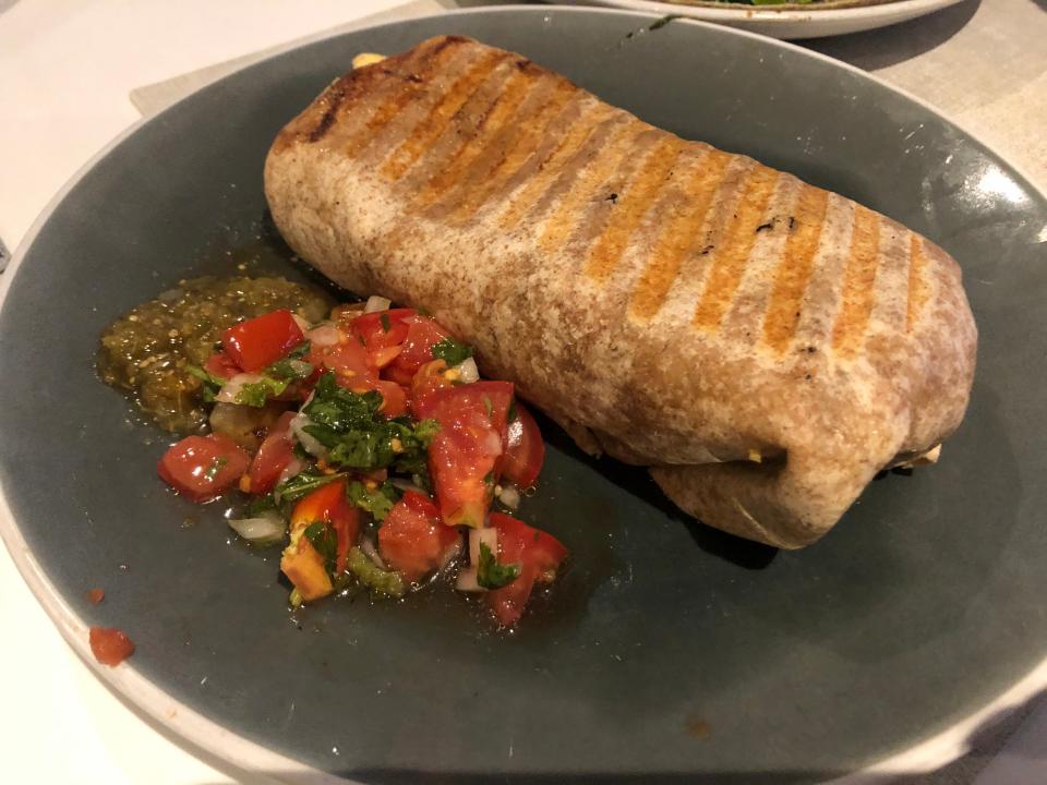 Guy Fieri breakfast burrito on plate with salsa