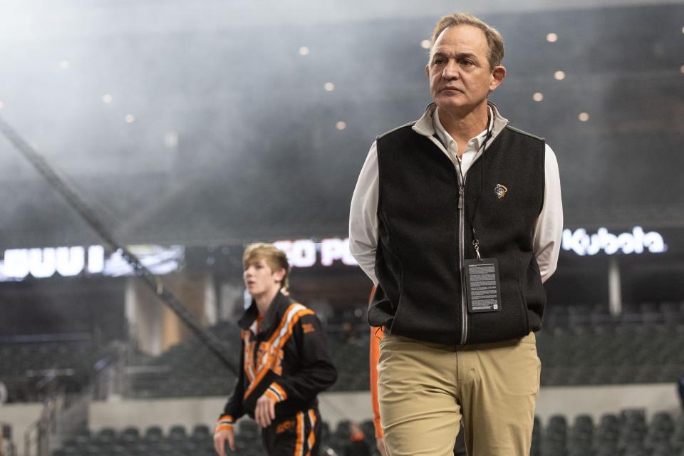 OSU wrestling coach John Smith surveys the action against Michigan on Friday night during the Bout at the Ballpark at Globe Life Field in Arlington, Texas.