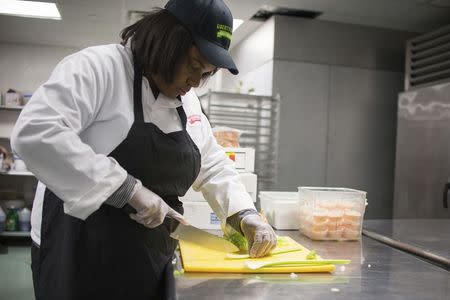 A student prepares food in a kitchen in this January 15, 2015 handout photo provided by Liberty's Kitchen in New Orleans, Louisiana, March 3, 2015. REUTERS/Liberty's Kitchen/Handout via Reuters