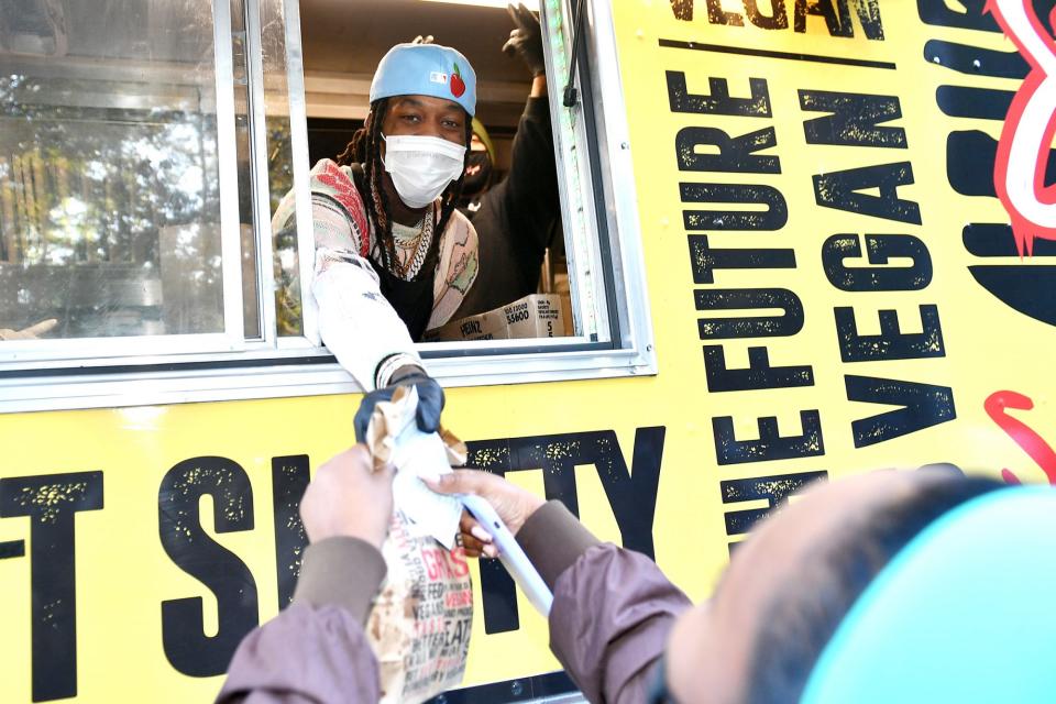 <p>Offset hands out hot meals during an Election Day Pop-Up event on Tuesday in Atlanta.</p>