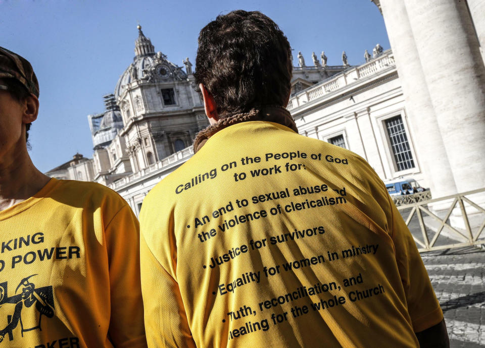 Demonstrators wear shirts as they stand outside St. Peter's Square on the day of the opening of a sex abuse within the Catholic church prevention summit, at the Vatican, Thursday, Feb. 21, 2019. Pope Francis opened a landmark sex abuse prevention summit Thursday by warning senior Catholic figures that the faithful are demanding concrete action against predator priests and not just words of condemnation. (Giuseppe Lami/ANSA via AP)