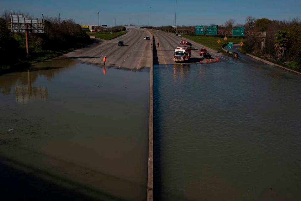 Water spills out onto I-610 after a 96-inch water main that supplies water to 40% to 50% of Houston burst while being repaired for a gradual leak on Feb. 27, 2020 in Houston, Texas. Emergency personnel rescued three people out of their vehicles.