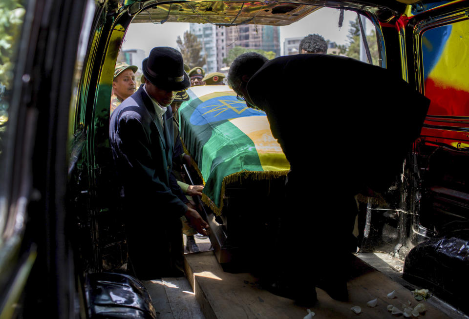 The coffin of assassinated army chief Gen. Seare Mekonnen is taken away for burial after a state ceremony at the Millennium Hall in the capital Addis Ababa, Ethiopia Tuesday, June 25, 2019. Ethiopia's Prime Minister Abiy Ahmed sobbed openly at the service Tuesday for the military chief who was assassinated by his own bodyguard over the weekend. (AP Photo/Mulugeta Ayene)